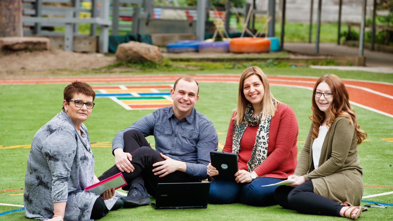 Group of teachers sitting outdoors