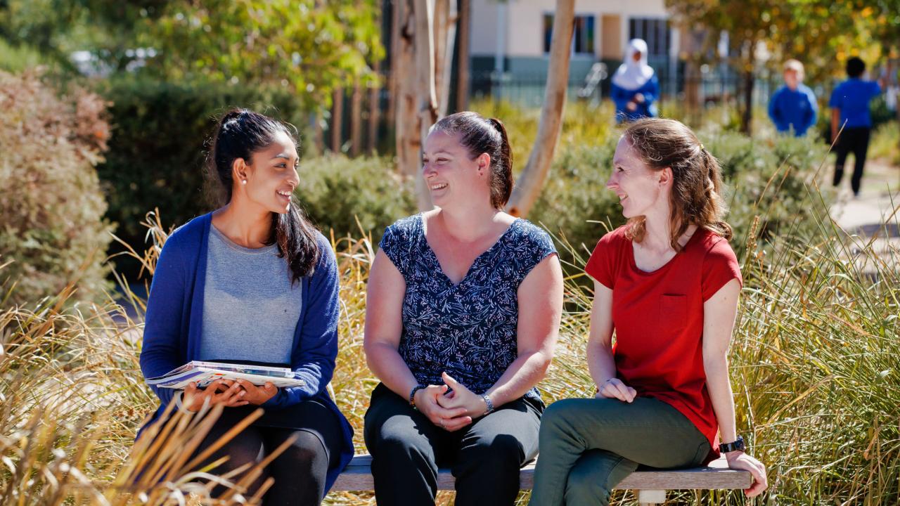Women leaders in a school having a discussion outside