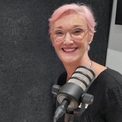Woman smiling while recording a podcast